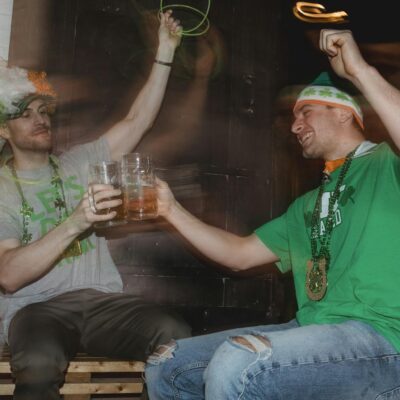 Happy friends celebrating national holiday drinking beer